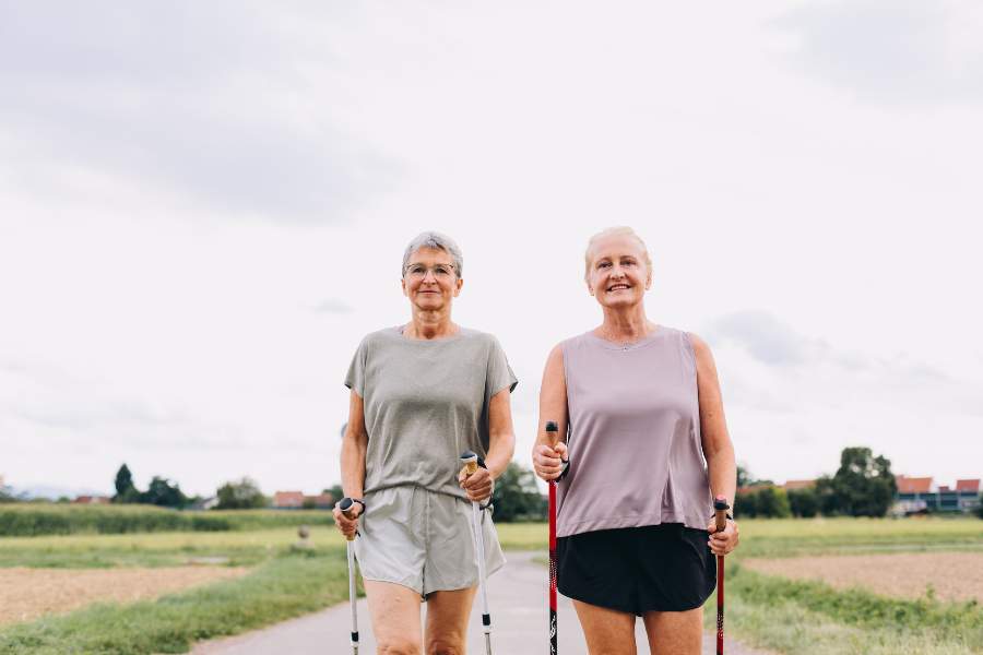 Two Mature Women walking with sticks